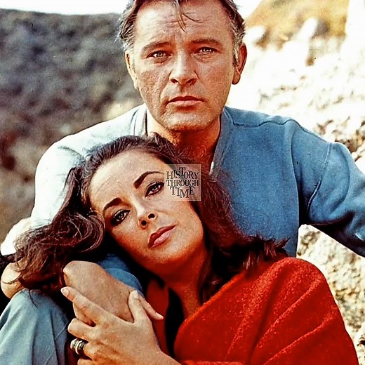 "Circa the early 1960s, Elizabeth Taylor and Richard Burton’s legendary romance ignited on the set of Cleopatra, where their undeniable chemistry captivated both audiences and the press. They married for the first time in 1964 in Montreal, beginning one of Hollywood’s most talked-about love stories. Despite their fiery personalities, the couple shared a deep artistic bond and starred together in several acclaimed films, including Who’s Afraid of Virginia Woolf? (1966). After divorcing in 1974, t