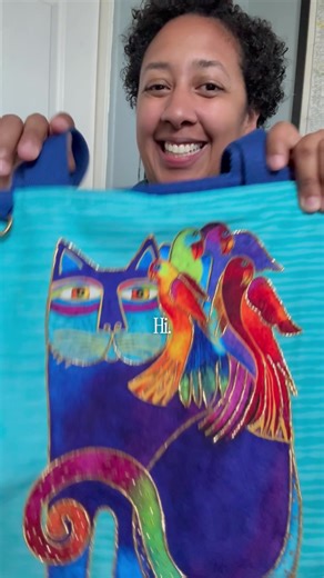 Meet Micquie a kindred spirit, creative mom, and lifelong Laurel Burch fan. She grew up surrounded by Laurel’s art and now gets to carry a little of that magic into her everyday life with our Catmandu tote right by her side. Between mom duties, creative projects, and everyday chaos, she needs a bag that can do it all and still reflect her personality. Bright, joyful, and colorful inside and out. @heymicquie 💙🐈 #laurelburchstudios #catmandu #kindredspirits #boldandcolorful #artistmomlife