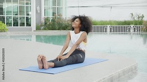 Young African American woman doing exercise with stretch muscles lag in the poolside, female training practicing workout with exercise for bodycare in the swimming pool, flexible of body.