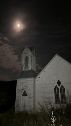 A church in West Virgina under a full moon. | church window