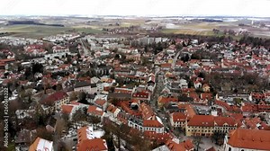Aerial view over Dachau, Germany. The small city is filmed on a winters day. Light snow on the streets and the weather is cloudy.