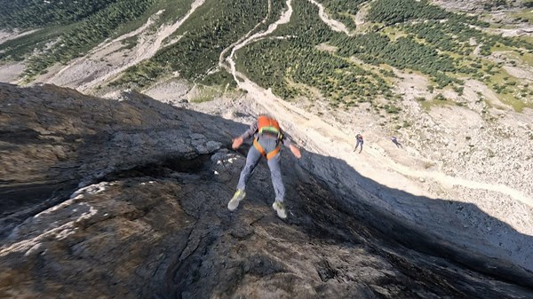 Man nose-dives down a cliff