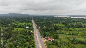Drone video of transportation and communication infrastructure in the Thai countryside, with a highway and cell tower.