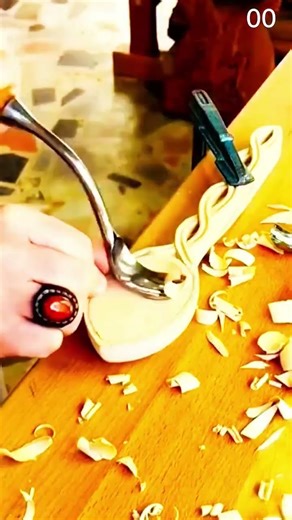 Carving ornate spoon handle with curved gouge