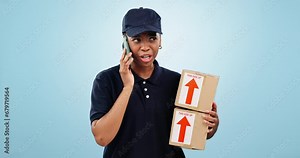 Delivery, stress and phone call by woman in studio with box, order or cargo crisis on blue background. Distribution, fail or lady courier with smartphone conflict for logistics, mistake or disaster