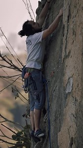 Stock Video Mountaineer Climbing A Rocky Vertical Mountain Live Wallpaper