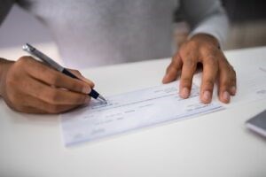 Can You Sign Over a Settlement Check? | CEO Lawyer