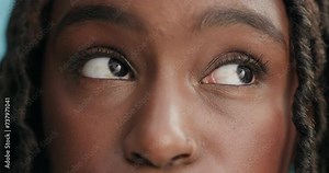 Face, black woman and eye with annoyed attitude in studio on blue background, bored and in disbelief. Serious, rolling eyes and frustrated with disappointment and unhappy mood with doubt and confused Stock Video