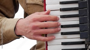 Musician playing the accordion. Hand playing accordions closeup. Accordion player.