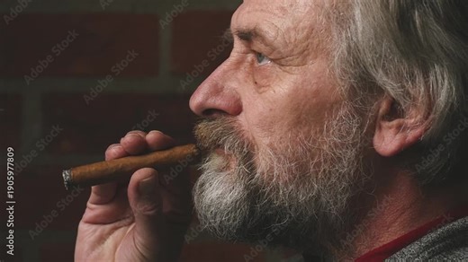 Older man smoking on balcony classic big cigar in detail video footage