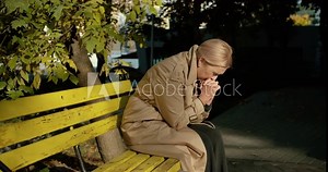 Sad senior woman crying alone in park, feeling desperate and stressed, divorce