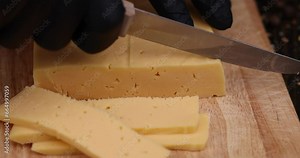 semi- hard cheese with holes cut into chunks , preparation of yellow cheese for use in cooking