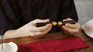 tea master with instrument at tea ceremony