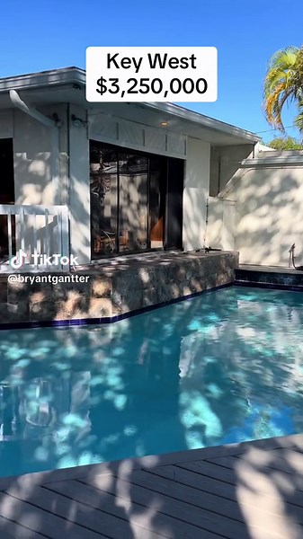 New listing in Midtown West! Discover a unique property located in the heart of Key West, featuring a double corner lot of 12,400 square feet with two swimming pools and ample living space. Key features of this property include a stunning chef's kitchen equipped with a gas range, abundant cabinet space, a double oven, and sleek granite countertops. Ideal for entertaining, the formal living room boasts a coral fireplace, while the family room opens to a decked area surrounded by pools and lush tr