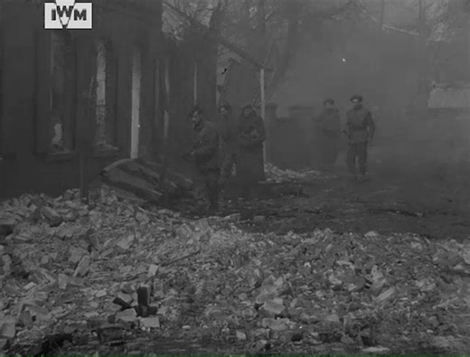 Soldiers of the 23rd Hussars, 11th Armoured Division, cross a canal north of Osnabrück, Germany, and liberate Yugoslav prisoners from an officers' prison camp at Eversheide, 3 April 1945. Film: IWM A70 289-3 | Imperial War Museum London