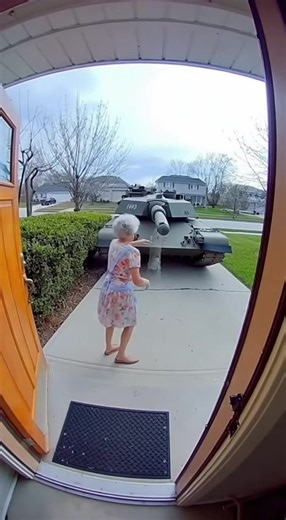 An elderly grandma opens her front door only to find a massive military tank parked right in front of her house. Instead of being scared, she starts screaming and hitting the tank with her hands, trying to shoo it away like an unwanted visitor! | Funny AI Videos