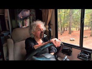 Solo woman driving a 34' Class A RV, backing into level campsite, and setting up water & electric.