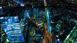A night timelapse of cityscape at the urban city in Tokyo wide shot high angle panning