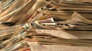 Old newspaper stack being shown from start to end