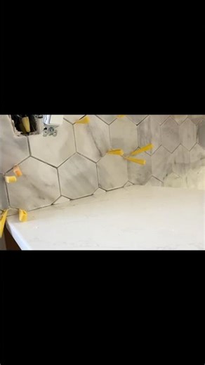 A marble mosaic backsplash provides a luxurious, timeless, and durable design element.