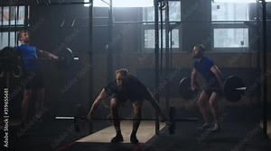 Three fitness man bodybuilder training using barbell weightlifting exercise muscular sportsman power lifting heavy weight doing squats in gym practice enjoying healthy lifestyle.