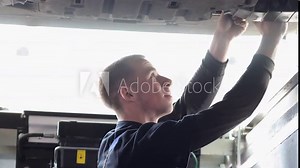 Auto mechanic adjustment automobile wheel alignment work at repair service station