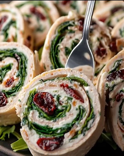 Homemade Turkey Cranberry Pinwheels Ingredients: 4 burrito-size or wrap-size tortillas 8 ounces cream cheese, softened ½ cup dried cranberries | The Cuisine Mile