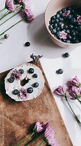 still life, bagel, cream cheese, bowl, blueberries, pretty flowers, arrangement, composition, visual, multimedia, footage, creative, content, camera angle, tabletop, floral display, interior design,