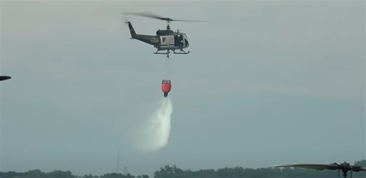 Watch helicopters drop water with unbelievable accuracy over fireworks blaze