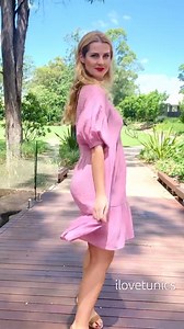 Introducing our Soft Pink Tiered Tunic Dress, the perfect blend of elegance and comfort. Crafted from a luxurious linen and rayon mix, this A-line dress features a V-neckline, short elasticated sleeves, and a tiered skirt that gracefully falls above the knee. Designed to hide any bumps and lumps, this non-stretch fabric dress is sure to make you feel like a sophisticated and exclusive fashionista. Sz 10 to 20 available at I❤Tunics here: t.ly/7O8Br Model is 5ft 8in or 173 cm | I Love Tunics.com -