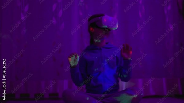 Girl Using Virtual Reality Headset And Looking Around At Interactive Technology With Colorful Illumination. VR Entertainment Immersive. Girl Wearing VR Headset in World of Virtual Reality Interacting.