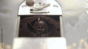 Inserting Antique Sewing Machine Looper