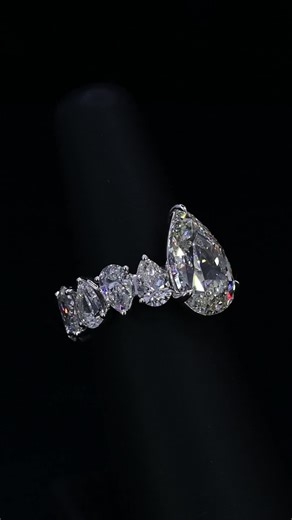 Bez Ambar on Instagram: "A perfect harmony of pears.⁠ A dazzling pear-shaped center stone embraced by a cascade of matching side diamonds — symmetry, brilliance, and bold elegance in one.⁠ ⁠ #pearshapediamond #finejewelry #diamondring #bespokedesign #brandbuilding #diamonds⁠ ⁠"