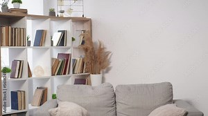 Passion love. Excited couple. Home intimacy. Happy beloved man and woman kissing and hiding under sofa embracing light room interior.