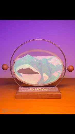 physicsfun on Instagram: "Wham-O Magic Window: one of my favorite vintage toys in my collection, a popular 1970s toy with immiscible sand like substances interacting under gravity to create images that evoke seascapes and mountains. Shown here is a retail store display stand from 1971 with the rare glow-in-the-dark “Crystal Fantasy” version of this kinetic art toy, which looks amazing when illuminated by a blacklight- and when all light is off. Unlike most shifting sand devices available today, 