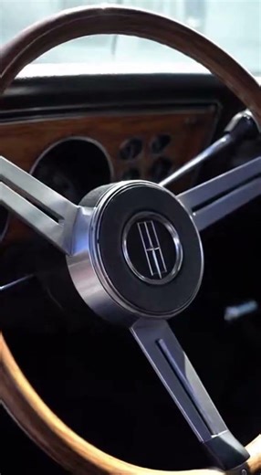 viral car reel style video 1975 Oldsmobile Cutlass Donk with giant chrome wheels parked on empty a