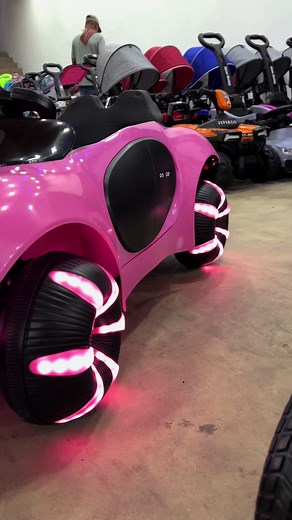 Futuristic Pink Children's Car with Glowing Wheels