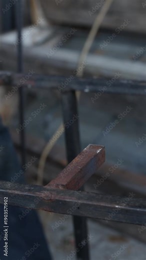 Working with an angle grinder in violation of safety rules. Cutting reinforcement with a grinder, close-up. Construction or repair work. A man works with a grinder with a metal disc, sparks fly