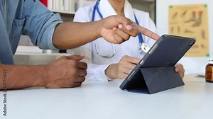 Doctor showing a patient some information on a digital tablet. Health examination and treatment of disease.