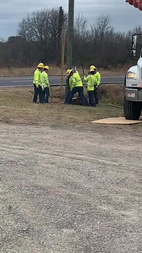 Utility Pole Maintenance by Construction Workers