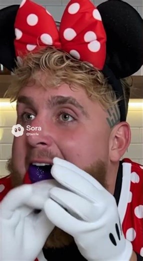 Jake Paul eating color donuts in costume