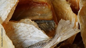 Dry fish snack for beer and drinks yellowstripe scad close-up. The yellowstripe scad is commonly used as a dried fish snack in Asian countries, processed either by salting, curing or mechanical drying
