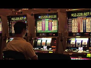 Megabucks Slot Machine in Las Vegas Casino with a Player Pulling Lever Trying for a Winning Jackpot