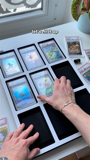Robs - Pokemon Collector on Instagram: "Unboxed the new Vaulted Card Display today — a clean white carbon design that holds nine graded cards and instantly upgrades any setup. I filled it with some of my favorite slabs and the final result looks incredible on my desk. If you collect Pokémon cards or love adding aesthetic display pieces to your space, this kind of frame is such a game changer for showcasing your best pulls. Which nine cards would you put in yours?"