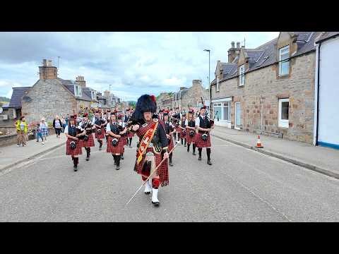 Drum Major leads Dufftown Pipe Band street march before 2025 Dufftown Highland Games in Scotland