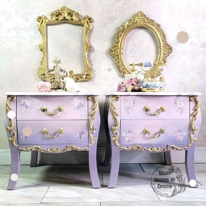 Introducing our Curvy Soft Pink Side Tables – the epitome of elegance and femininity! This matching pair is designed to grace your bedroom or living room with sophistication and style. Their soft pink hue beautifully complements the delicate gold accents, creating a perfect harmony of colors. Adorned with intricate floral patterns on the sides, these tables boast a unique charm that adds dimension to any space. The added decals scream luxury, making them a statement piece in your home decor. To 