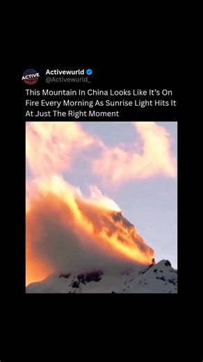 Active Wurld ® on Instagram: "👉Follow @activewurld for more videos like this At daybreak, one mountain in China puts on a stunning illusion that makes it seem as if flames are rolling across its summit. What’s really happening is a rare lighting effect that occurs just after sunrise. When the sun sits low on the horizon, its rays strike the icy peak at a precise angle, causing the surface to glow with deep amber and crimson tones. Thin clouds and drifting fog scatter the light, spreading the co