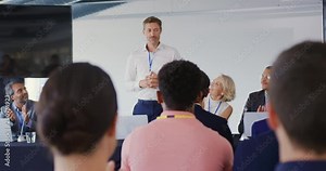 Speaker addressing the audience at a business conference