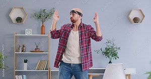 Dancing active happy man, funny cool dancer home dancing alone. Showing amusing mood, entertaining or enjoyable move for pleasure, playful guy having fun, party disco joy, physically energetic person