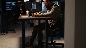 Software developer typing source code on laptop and multiple monitors, using programming language to create firewall security server. Male coder developing database cloud computing.